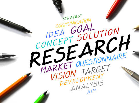 "Research" - handwritten words, pens, white background.