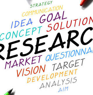 "Research" - handwritten words, pens, white background.